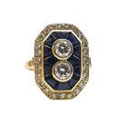Bague ancienne en or jaune 18 carats sertie de deux diamants naturels entourés de saphirs calibrés et d'un pavage de diamants, bijou ancien proposé par GemmeLuxe.